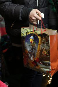 Nikolaustüte in Händen, Händedruck